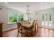 Dining room featuring wood floors, a modern chandelier, and large windows at 1755 Simplicity Rd, Concord, NC 28025