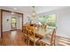 Bright dining room with wood floors, a modern chandelier, and large windows to backyard at 1755 Simplicity Rd, Concord, NC 28025