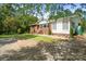 Charming home with brick and white wood accents, a well-manicured lawn, and mature trees at 1755 Simplicity Rd, Concord, NC 28025