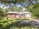 Charming brick home with a spacious front yard and mature trees providing ample shade at 1755 Simplicity Rd, Concord, NC 28025