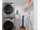 Laundry room with modern, stacked washer and dryer and shelving for storage at 1755 Simplicity Rd, Concord, NC 28025