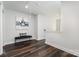 Hallway with dark wood flooring, an abstract art piece and bench seating at 1809 Country Club Rd, Lincolnton, NC 10757