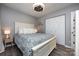 Comfortable bedroom featuring a large bed with patterned bedding, ceiling fan and a double door closet at 18861 Vineyard Point Ln, Cornelius, NC 28031