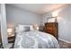 Comfortable bedroom with modern dresser, wooden floors and ladder decor accents at 18861 Vineyard Point Ln, Cornelius, NC 28031