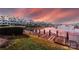 Picturesque dock and marina view with waterfront condos, boats and sunset background at 18861 Vineyard Point Ln, Cornelius, NC 28031