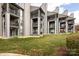 View of the back of the condominium complex showing grassy yards and private patios at 18861 Vineyard Point Ln, Cornelius, NC 28031