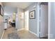 Hallway view with tile floors, doorways to other rooms, and neutral wall colors at 18861 Vineyard Point Ln, Cornelius, NC 28031