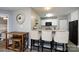 Stylish kitchen features a breakfast bar with seating, granite countertops, and modern appliances at 18861 Vineyard Point Ln, Cornelius, NC 28031