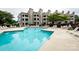 Exterior image of a condominium complex with a community pool and plenty of lounge seating at 18861 Vineyard Point Ln, Cornelius, NC 28031