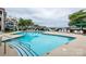 Condominium complex swimming pool with lounge chairs and lake views in the background at 18861 Vineyard Point Ln, Cornelius, NC 28031
