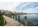 Waterfront condos and wooden pier showcasing a beautiful harbor with many boats and a cloudy sky at 18861 Vineyard Point Ln, Cornelius, NC 28031
