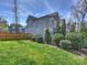 Well-maintained backyard with lush green lawn, manicured bushes, and a charming iron fence at 1905 Summey Ave, Charlotte, NC 28205