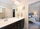 Double vanity bathroom featuring dark wood cabinets, white countertops, and adjacent bedroom view, offering style and convenience at 1905 Summey Ave, Charlotte, NC 28205
