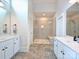 Bright bathroom features double vanities, large shower with bench, and elegant tile flooring, creating a luxurious space at 1905 Summey Ave, Charlotte, NC 28205