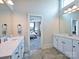 Bathroom with double sinks, marble countertops, tile flooring, and open view to the bedroom, offering style and comfort at 1905 Summey Ave, Charlotte, NC 28205
