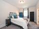 Cozy bedroom with neutral walls, grey accents, carpet, and natural light from a window, creating a comfortable retreat at 1905 Summey Ave, Charlotte, NC 28205