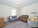 Bright bedroom features hardwood floors, neutral paint, and seating, creating a stylish and inviting space at 1905 Summey Ave, Charlotte, NC 28205