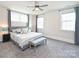 Serene main bedroom featuring a ceiling fan, bench, and ample natural light at 1905 Summey Ave, Charlotte, NC 28205