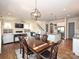 Inviting open-concept dining room and living room with hardwood floors and modern lighting fixtures at 1905 Summey Ave, Charlotte, NC 28205