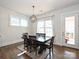 Cozy dining room with a wooden table, modern chandelier, and large windows at 1905 Summey Ave, Charlotte, NC 28205