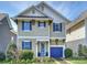 Charming two-story home featuring light yellow siding and bright blue shutters on a sunny day at 1905 Summey Ave, Charlotte, NC 28205