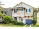 Charming two-story home with a light yellow exterior, blue shutters, and an attached garage at 1905 Summey Ave, Charlotte, NC 28205