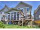 Exterior view showcasing the back of the house with a screened in porch and outdoor patio at 1905 Summey Ave, Charlotte, NC 28205