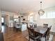 Open-concept kitchen and dining area with a central island, granite countertops, and stainless steel appliances at 1905 Summey Ave, Charlotte, NC 28205