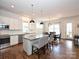 Open kitchen with a central island, stainless steel appliances, and hardwood floors at 1905 Summey Ave, Charlotte, NC 28205