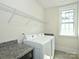 Bright laundry room with modern washer, dryer, countertop and shelving, providing convenience and efficiency at 1905 Summey Ave, Charlotte, NC 28205