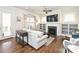 Inviting living room featuring a fireplace, built-in shelves, hardwood floors, and large windows at 1905 Summey Ave, Charlotte, NC 28205