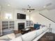 Comfortable living room featuring a fireplace, built-in shelves, and staircase at 1905 Summey Ave, Charlotte, NC 28205