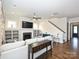 Cozy living room with a fireplace, hardwood floors, staircase, and built-in shelving at 1905 Summey Ave, Charlotte, NC 28205