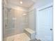 Modern shower with subway tile, bench, and glass door, offering a luxurious and stylish bathing experience at 1905 Summey Ave, Charlotte, NC 28205
