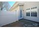 Cozy back patio with a white privacy fence, perfect for outdoor relaxation and privacy at 2021 Lennox Square Rd, Charlotte, NC 28210