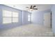 Bright bedroom featuring plush carpet, a ceiling fan, and large windows for natural light at 2021 Lennox Square Rd, Charlotte, NC 28210
