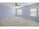 Spacious primary bedroom with plush carpet, ceiling fan and ample natural light at 2021 Lennox Square Rd, Charlotte, NC 28210