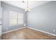 Well-lit dining room with a large window, hanging light fixture, and wood-look floors at 2021 Lennox Square Rd, Charlotte, NC 28210