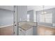 Partial kitchen view showing granite countertops, tiled backsplash and hardwood floors at 2021 Lennox Square Rd, Charlotte, NC 28210
