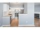 Updated kitchen features stainless steel appliances, white cabinets, granite countertops, and hardwood floors at 2021 Lennox Square Rd, Charlotte, NC 28210