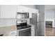 This kitchen features stainless steel appliances, white cabinets, granite countertops, and hardwood floors at 2021 Lennox Square Rd, Charlotte, NC 28210