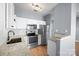 Modern kitchen boasts white cabinets, granite countertops, stainless steel appliances, and tile backsplash at 2021 Lennox Square Rd, Charlotte, NC 28210