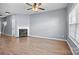 Cozy living room boasts a fireplace, ceiling fan, wood-look floors and natural light at 2021 Lennox Square Rd, Charlotte, NC 28210