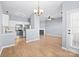 Open concept living area with a fireplace, hardwood floors, ceiling fan, kitchen, and lots of natural light at 2021 Lennox Square Rd, Charlotte, NC 28210