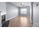 Inviting living room featuring a fireplace, wood-look floors and a bright window at 2021 Lennox Square Rd, Charlotte, NC 28210
