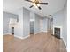 Open concept room with kitchen, stainless steel appliances, fireplace and wood-look flooring at 2021 Lennox Square Rd, Charlotte, NC 28210