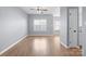 Bright living room features wood-look floors, neutral paint, and a ceiling fan at 2021 Lennox Square Rd, Charlotte, NC 28210