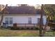 Rear exterior view showcasing a cozy wooden deck and a serene outdoor space perfect for relaxation at 2032 David Earl Dr, Charlotte, NC 28213