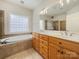 Bathroom featuring dual vanities, soaking tub, large mirror, and tile flooring at 2068 Brandt Rd, York, SC 29745