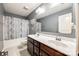 Bathroom featuring double sinks, a large mirror, and a shower with a blue patterned curtain at 2076 Brightflower Ln, York, SC 29745
